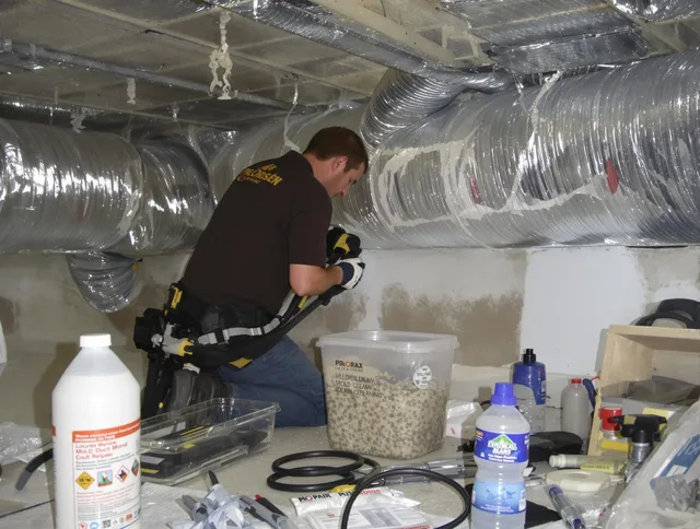 Norwell Air Duct Cleaning specialist performing professional mold removal from air ducts in Norwell