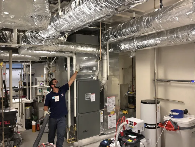 Norwell Air Duct Cleaning specialist performing thorough furnace duct cleaning in a Norwell residence