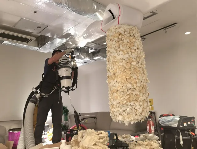 Norwell Air Duct Cleaning technician performing precision vacuum insulation removal in a residential property in Norwell