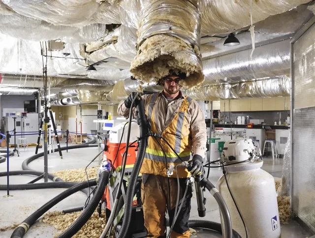 Professional vacuum insulation removal by Norwell Air Duct Cleaning expert in Norwell